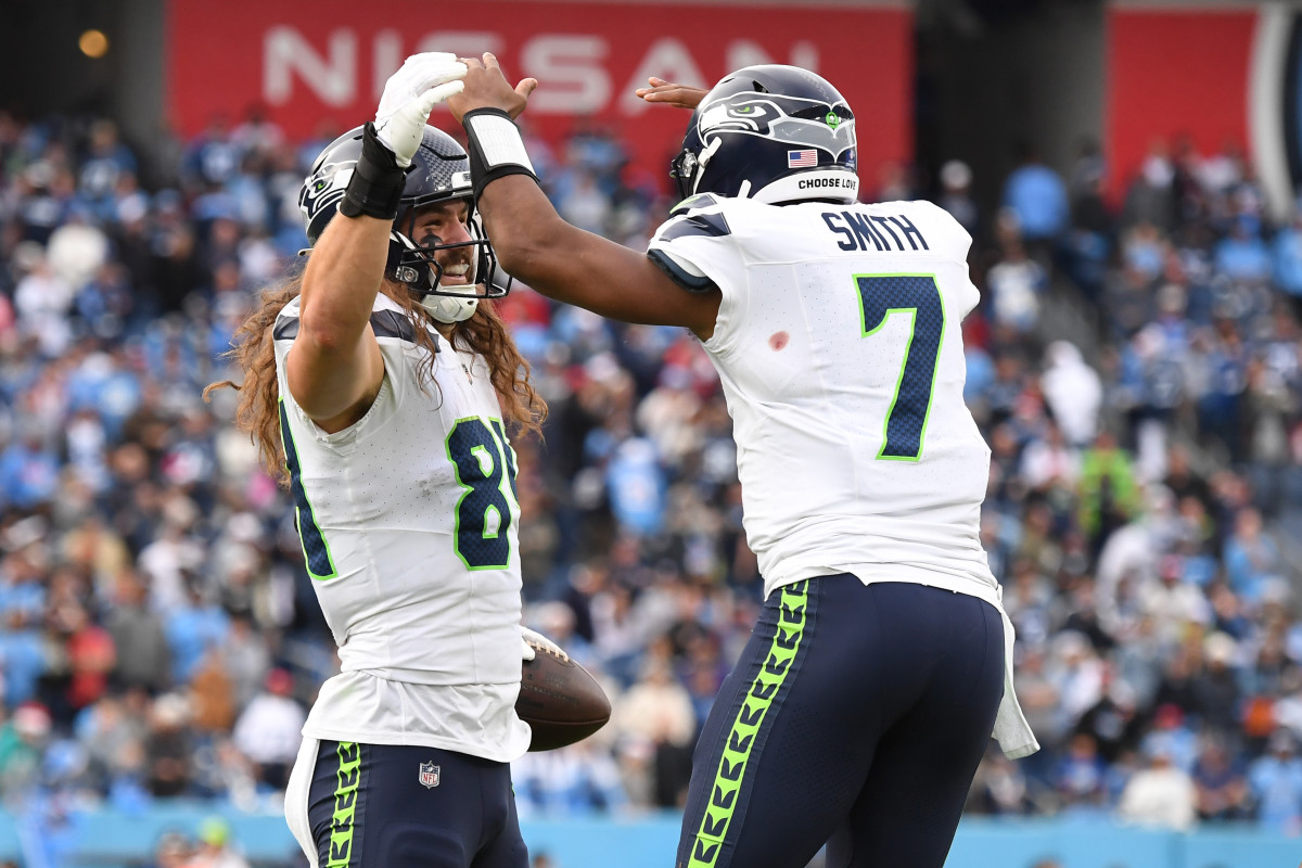 Dec 24, 2023; Nashville, Tennessee, USA; Seattle Seahawks tight end Colby Parkinson (84) celebrates with quarterback Geno Smith (7) after scoring the game-winning touchdown during the second half against the Tennessee Titans at Nissan Stadium. 
